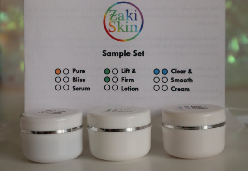 Photo of three small jars in front of a card saying Zaki Skin Sample Set